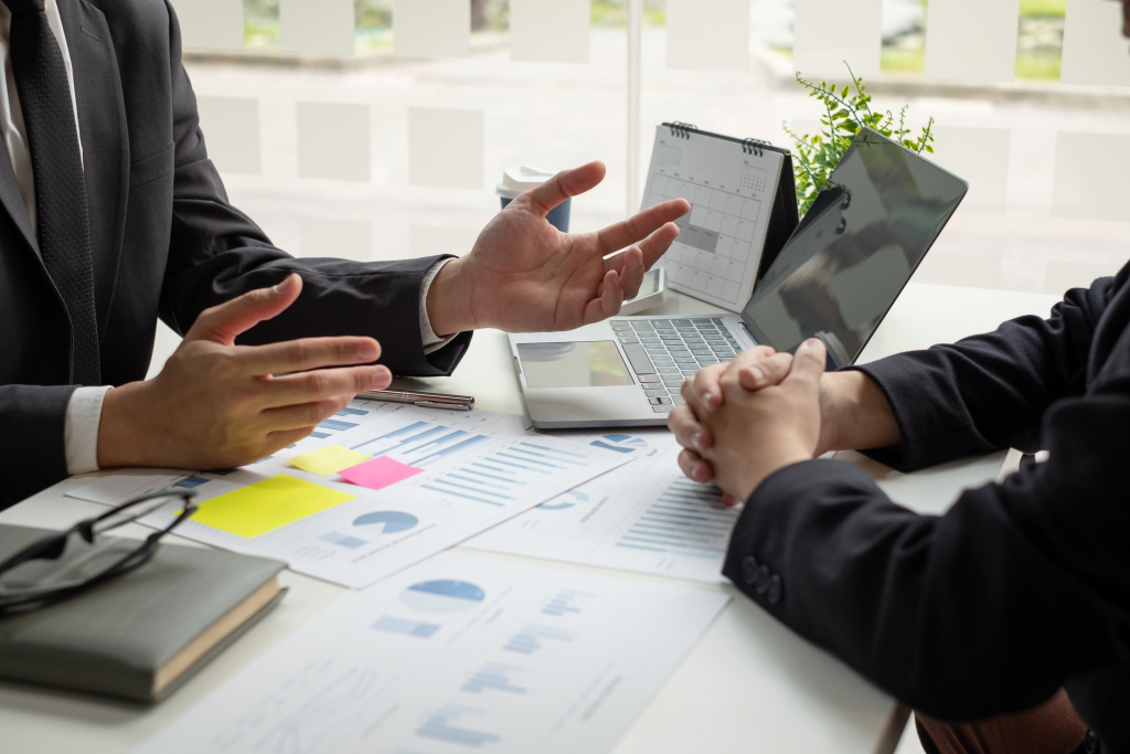 Business leaders talk about charts, financial graphs showing res